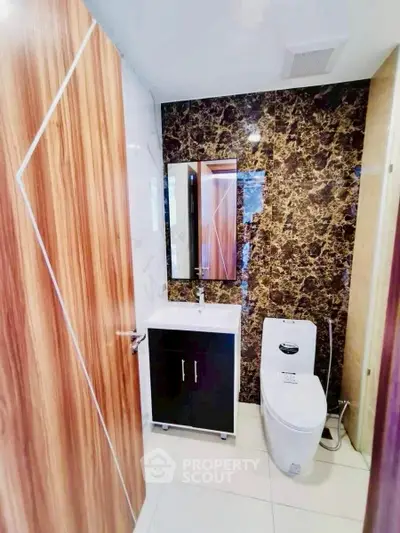 Modern bathroom with stylish marble wall and sleek fixtures