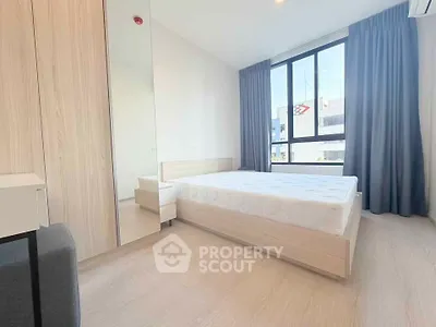 Bright and modern bedroom with large window and minimalist decor