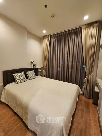 Cozy bedroom with elegant curtains and modern decor in a stylish apartment.