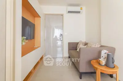 Modern living room with cozy sofa and wall-mounted TV in a stylish apartment.