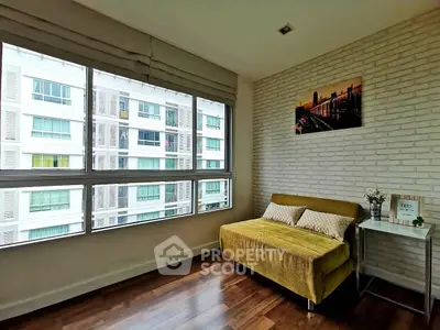 Modern living room with large windows and stylish decor in urban apartment