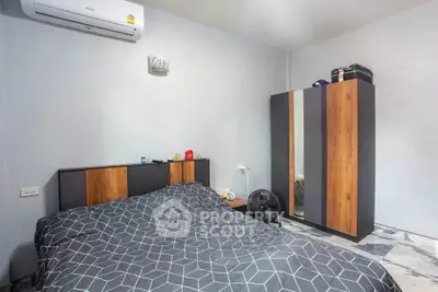 Modern bedroom with stylish wardrobe and air conditioning in a cozy apartment.