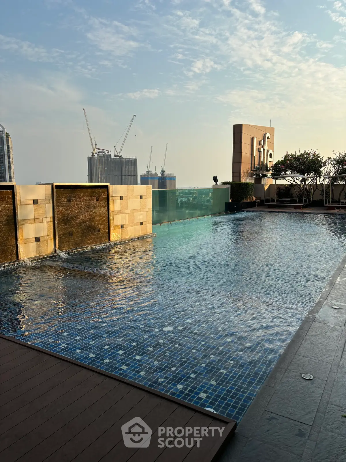 Luxurious rooftop pool with city skyline view, perfect for relaxation and leisure in a modern urban setting.