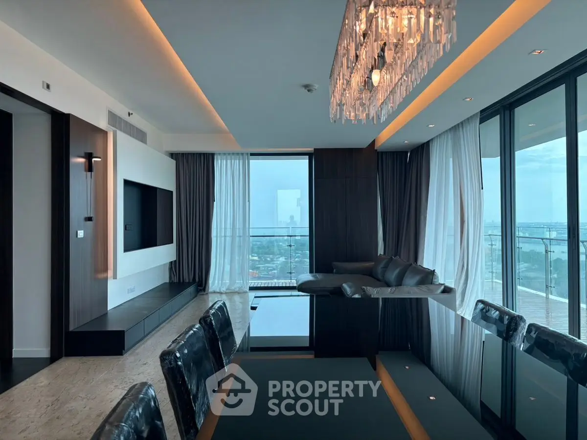 Luxurious modern living room with panoramic city view and elegant chandelier.