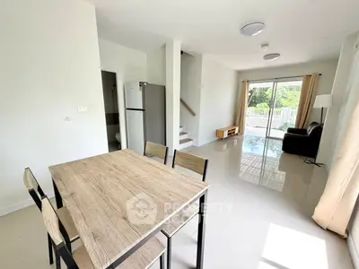 Spacious modern living room with dining area and garden view, perfect for family gatherings.