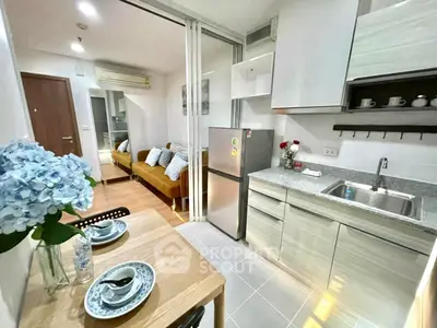 Modern open-plan kitchen and living area with stylish decor and natural light.