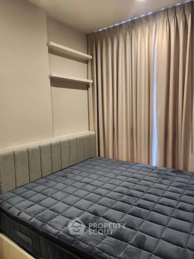 Modern bedroom with stylish bed and elegant curtains in a cozy apartment.