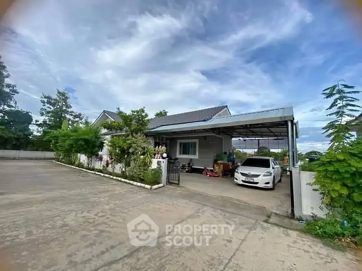 Charming suburban house with carport and lush greenery in a peaceful neighborhood.