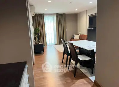 Modern open-plan living and dining area with stylish furniture and natural light.