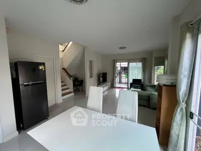 Spacious open-plan living room with modern kitchen and elegant dining area in a bright, airy home.