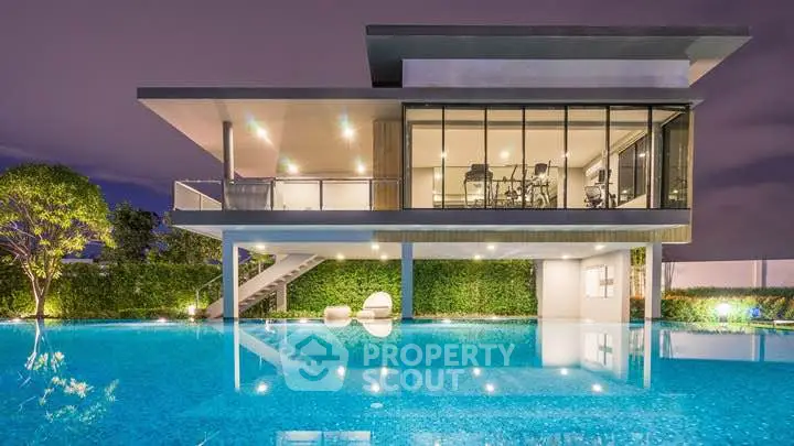 Luxurious modern home with stunning pool and gym at night