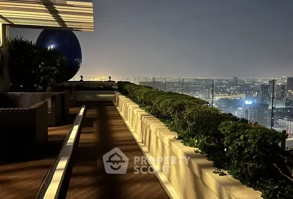 Luxurious rooftop terrace with stunning city skyline view at night.