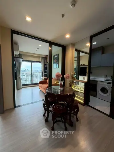 Stylish apartment interior with open living room and kitchen, featuring elegant furniture and city view.