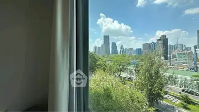 Stunning cityscape view from a high-rise apartment window, showcasing lush greenery and modern skyline.