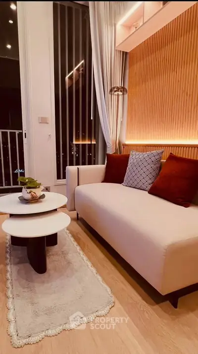 Stylish modern living room with elegant sofa and chic decor in a high-rise apartment.