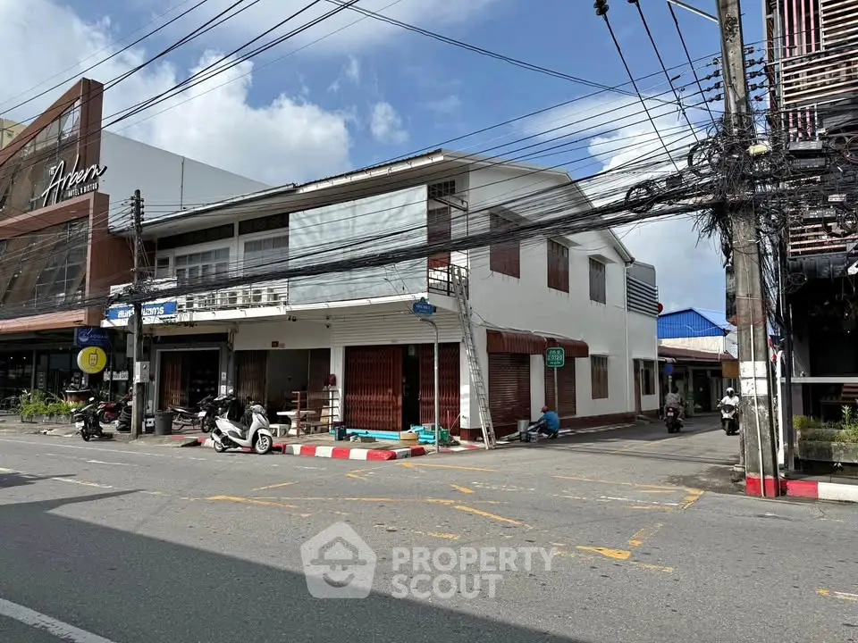 Charming corner commercial building with street view, ideal for retail or office space in bustling area.