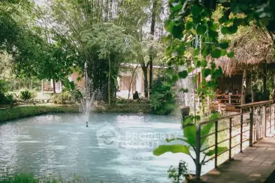 Charming garden view with serene pond and lush greenery, perfect for relaxation and outdoor enjoyment.