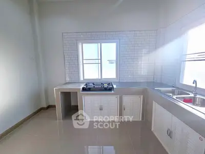 Modern kitchen with sleek gas stove and ample natural light
