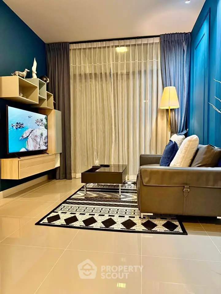 Modern living room with sleek furniture and stylish decor, featuring a wall-mounted TV and elegant curtains.