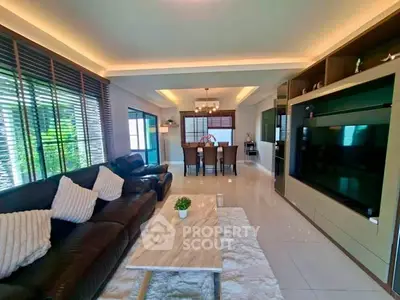 Spacious modern living room with elegant decor and large TV unit, perfect for family gatherings.