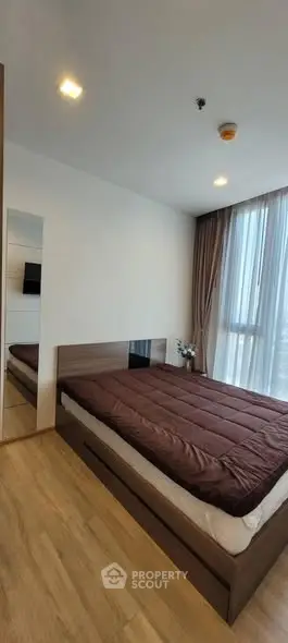 Modern bedroom with large window and stylish decor