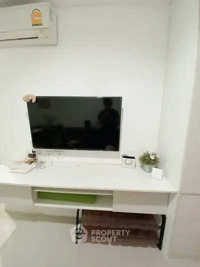 Modern living room with wall-mounted TV and minimalist decor