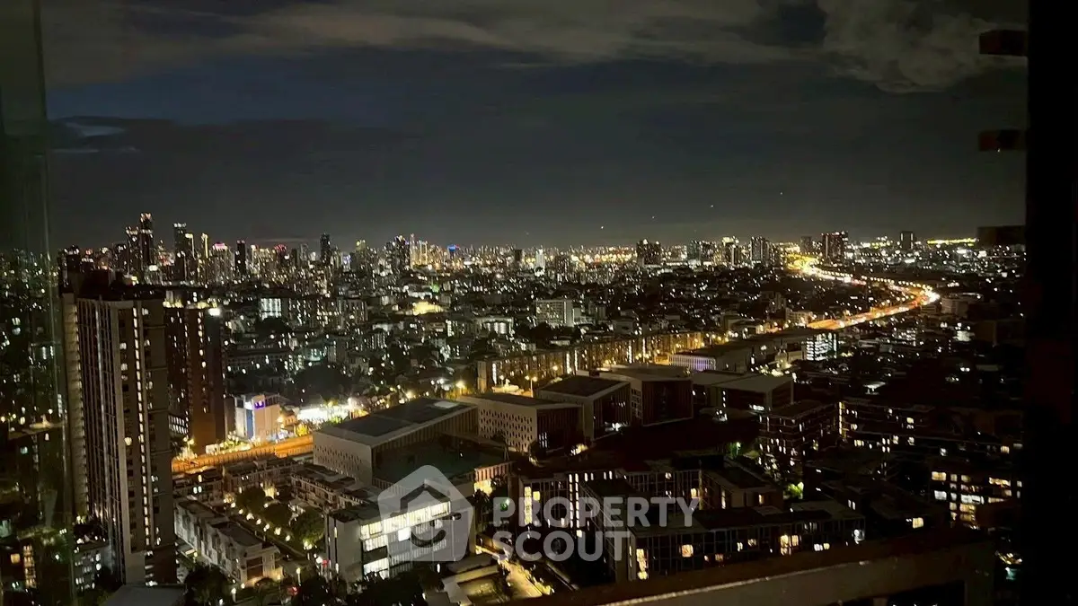 Stunning cityscape night view from high-rise apartment balcony showcasing vibrant urban lights.