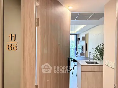 Modern apartment entrance with open kitchen and stylish interior design