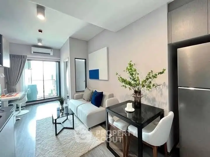 Modern living room with stylish decor and open layout, featuring a cozy sofa and dining area.
