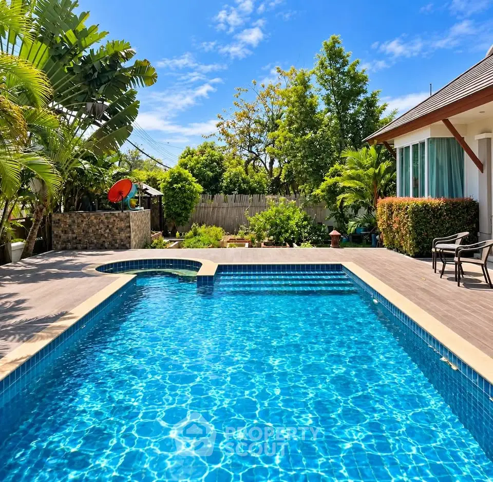Luxurious backyard with sparkling pool and lush greenery, perfect for relaxation and entertainment.