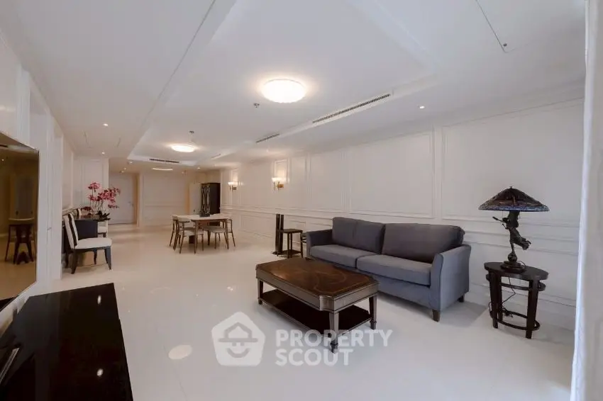 Spacious and elegant living room with modern furnishings and ample natural light.