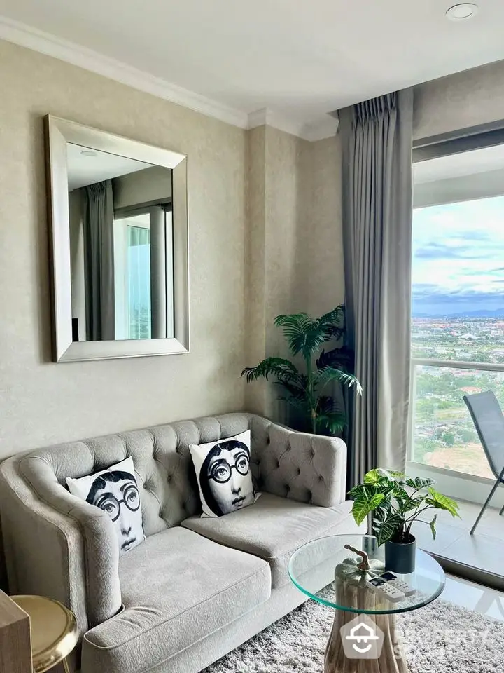 Stylish living room with plush sofa, artistic pillows, and panoramic window view