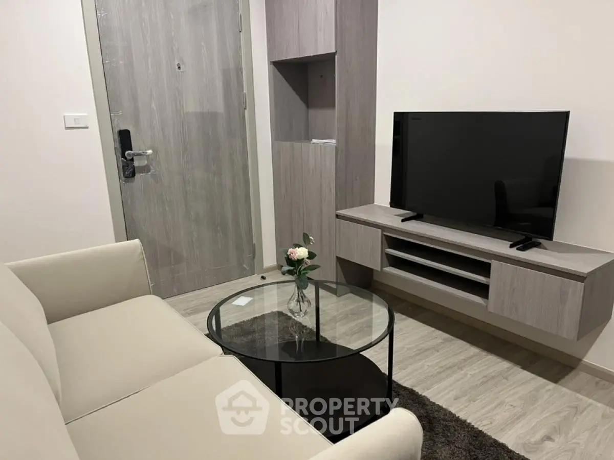 Modern living room with sleek furniture and mounted TV