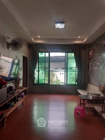 Spacious living room with large window and modern decor