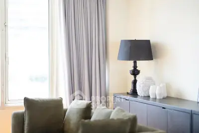 Elegant living room with stylish lamp and cozy sofa near window.