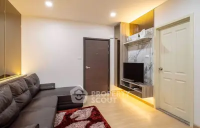 Modern living room with sleek leather sofa and stylish entertainment center