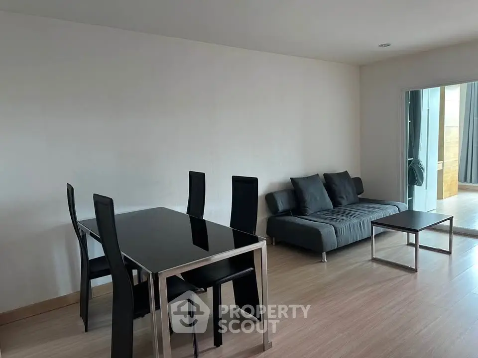 Modern living room with sleek black furniture and open layout
