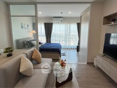 Modern open-plan living room with cozy bedroom and panoramic window view