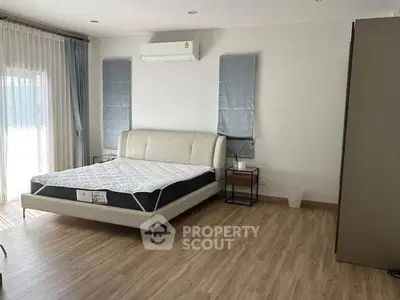 Spacious bedroom with modern decor and natural light