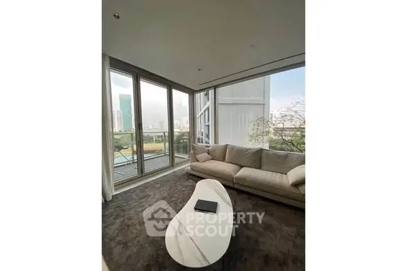 Luxurious corner living room with panoramic city views and elegant furnishings.