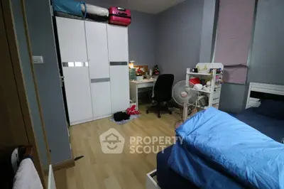 Cozy bedroom with modern wardrobe and study desk, ideal for comfortable living.