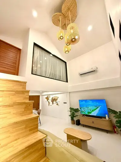 Modern living room with high ceiling, stylish lighting, and wooden staircase in a contemporary home.