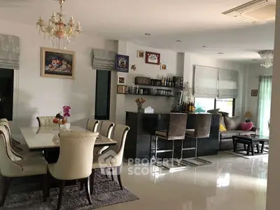 Elegant open-plan living and dining area with modern decor and bar counter