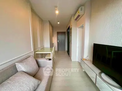 Modern living room with sleek furniture and air conditioning in a stylish apartment.