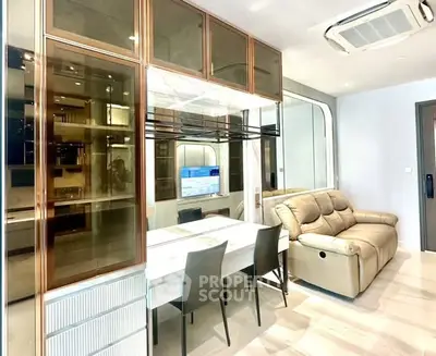 Modern living room with sleek furniture and built-in storage cabinets.