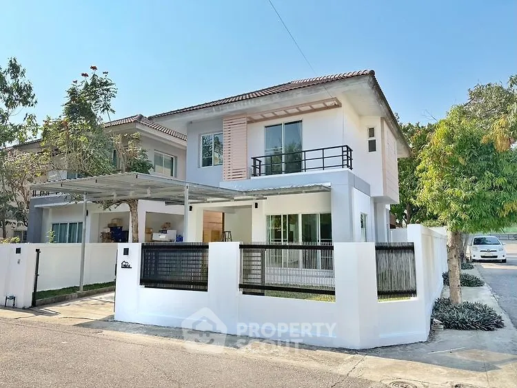 Charming two-story house with modern design and spacious yard in a serene neighborhood.