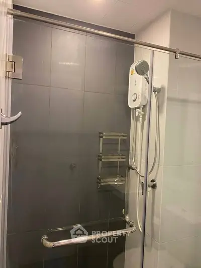 Modern bathroom with glass shower enclosure and sleek fixtures