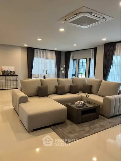 Spacious modern living room with elegant beige sofa and stylish decor