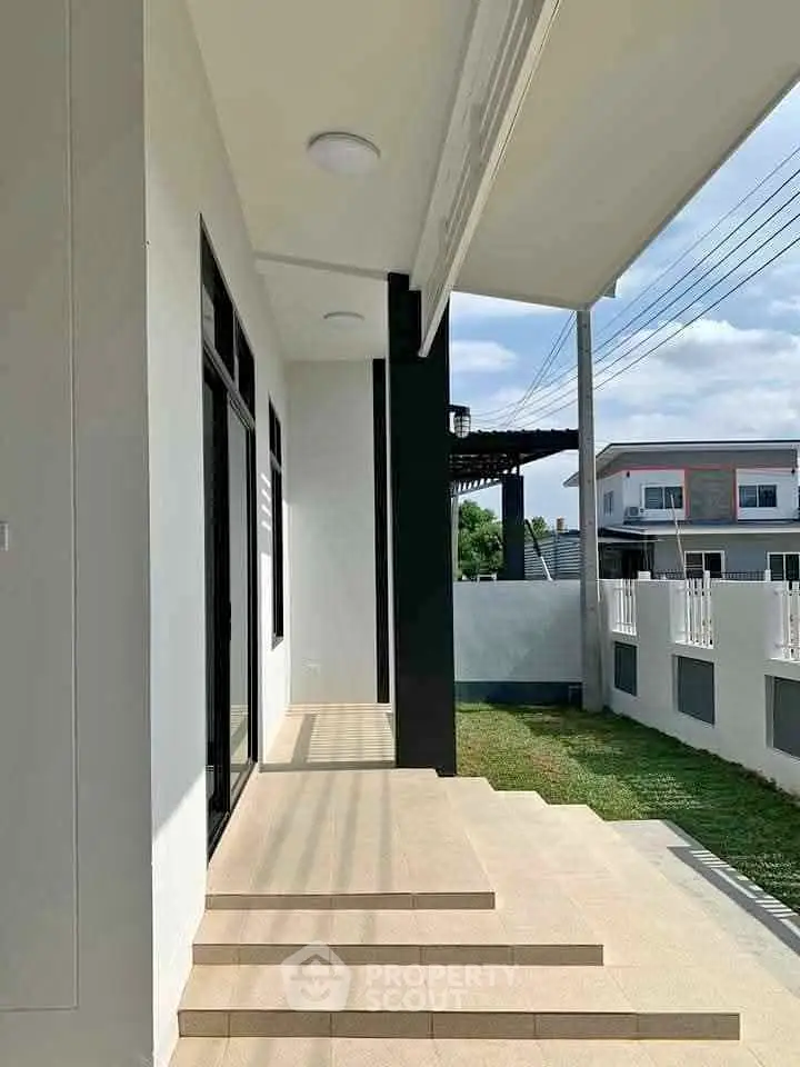 Modern exterior view of a stylish home with clean lines and spacious patio area.