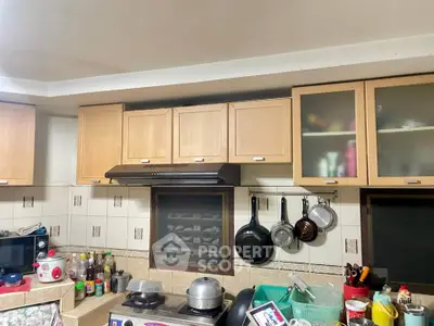 Cozy kitchen with wooden cabinets and modern appliances, perfect for culinary enthusiasts.